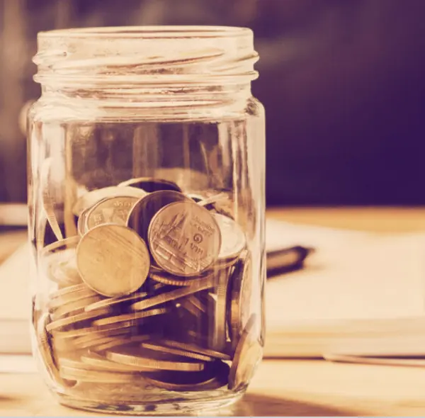 Glass jar filled with coins